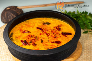 Traditional Angamaly Manga Curry with green mangoes in coconut milk gravy served in a clay pot